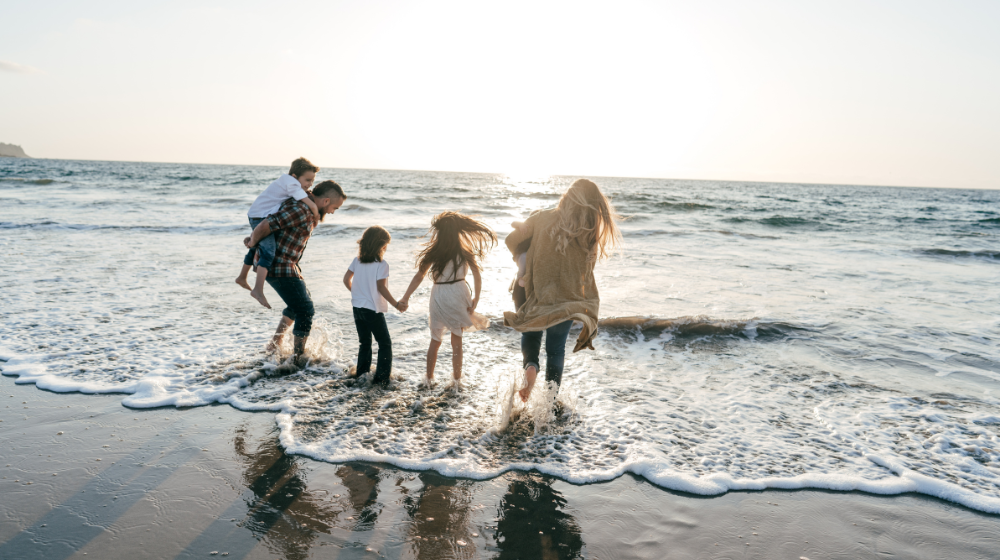 family running in the sea