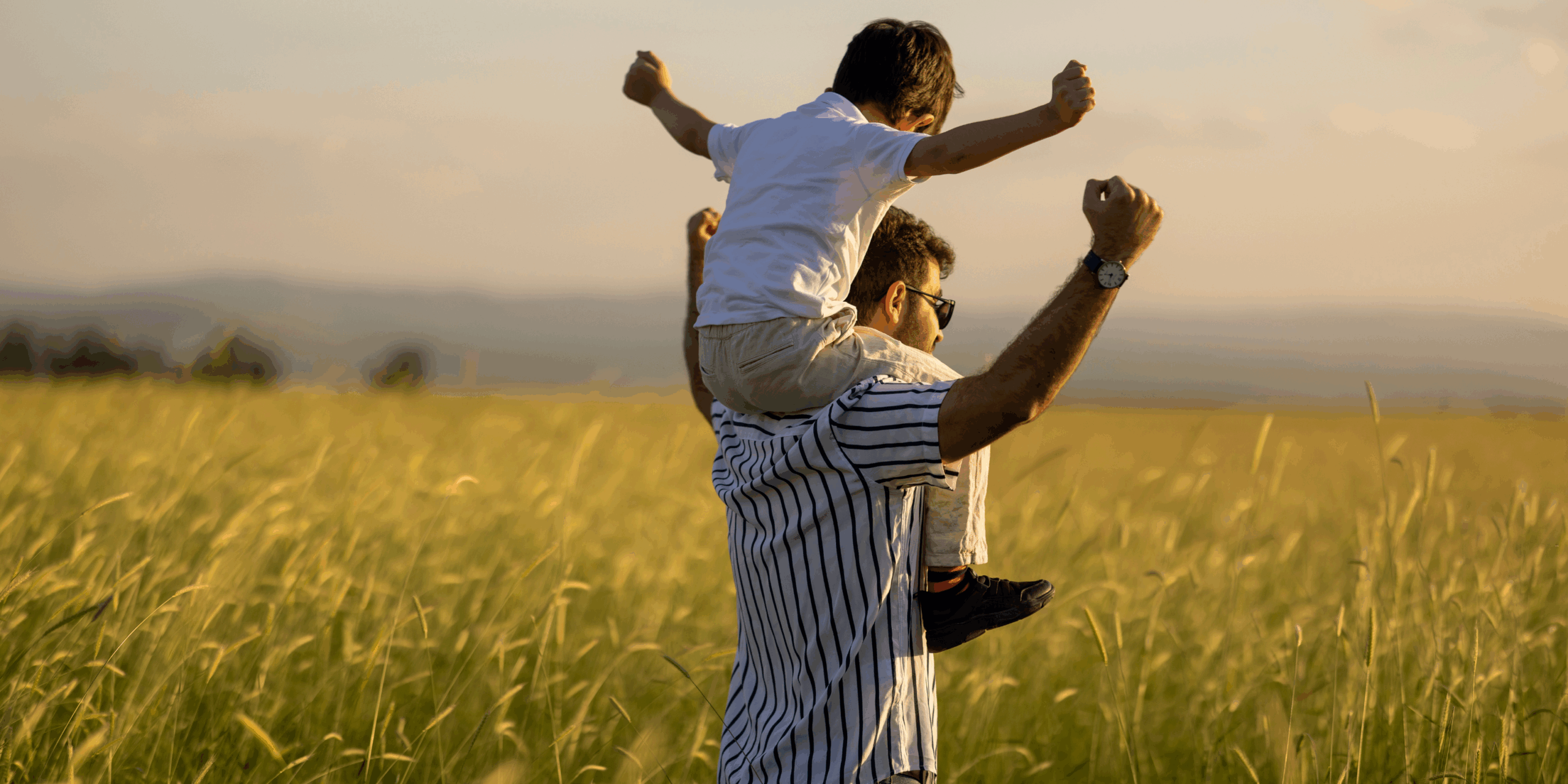 child with their dad in a corn field